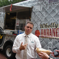 Resident dining manager Jeff McClure stands in front of one of two new food trucks coming to campus.